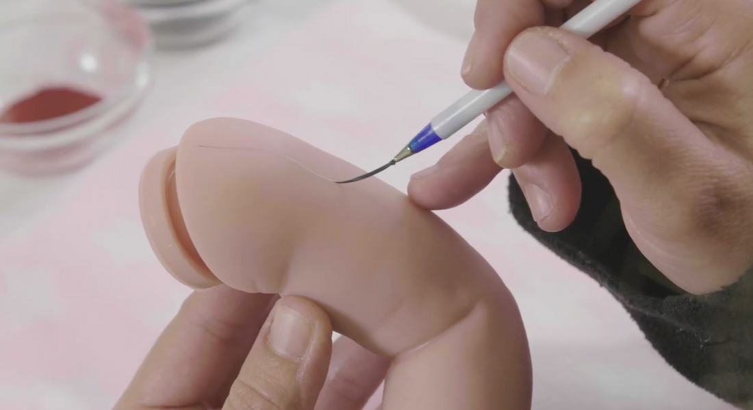 hand painting a reborn doll