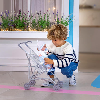 Child playing with doll and stroller